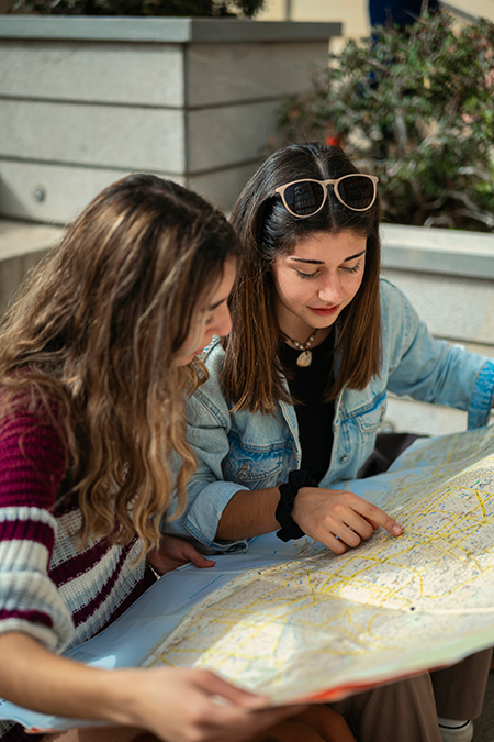 Two travelers studying a map together, planning their next trip